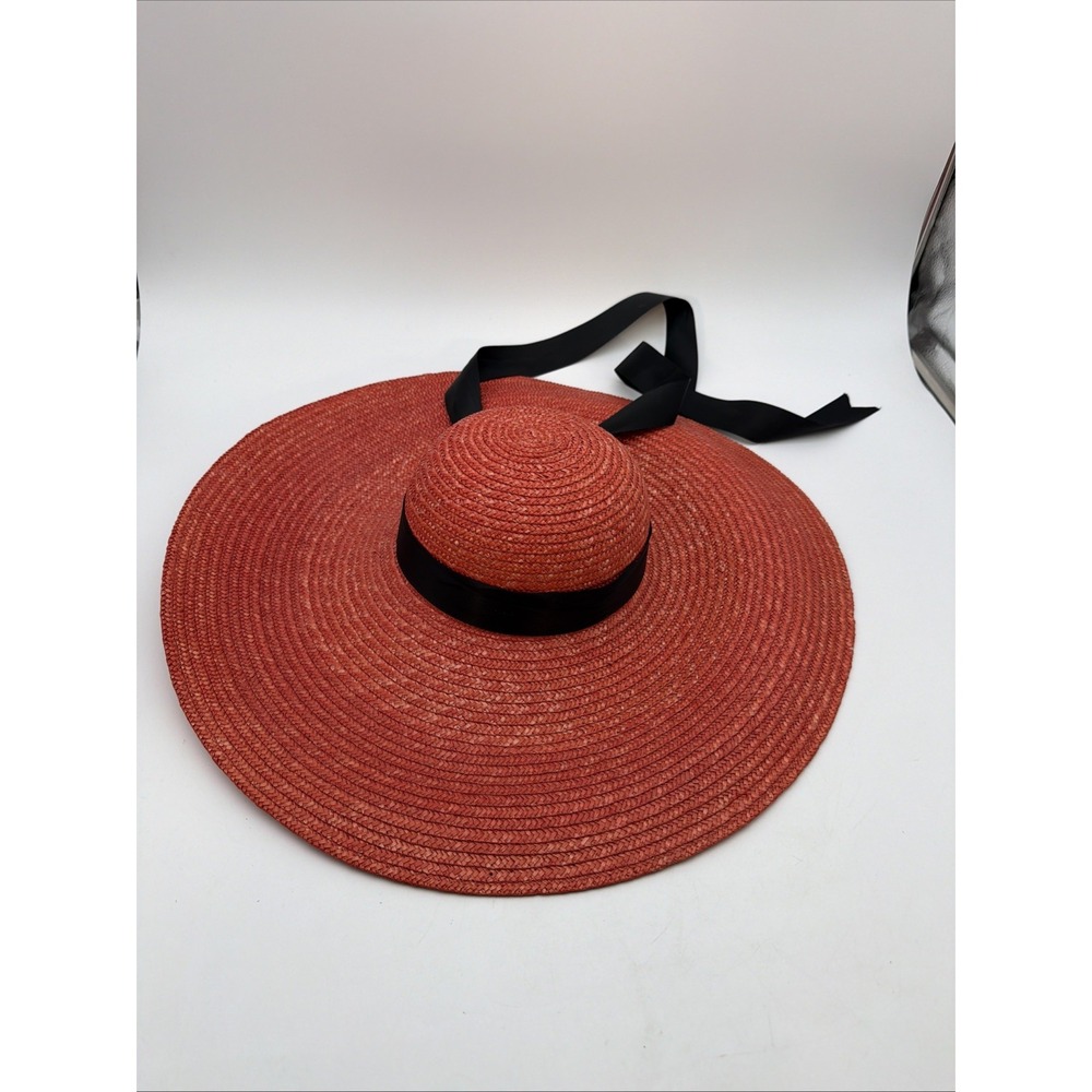 red wide-brim straw sun hat featuring a black ribbon band